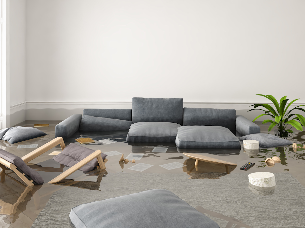 A couch, chairs, and other items submerged in water caused by spring flooding prevention
